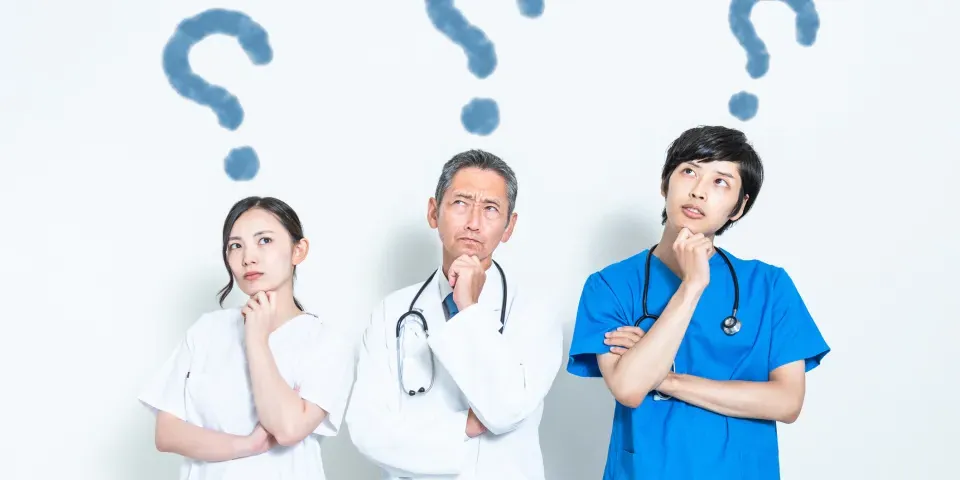 Three medical professionals deep in thought with question marks over their heads